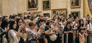 Digital and Culture meet, a crowd of people in a museum taking photos/filming with their phones
