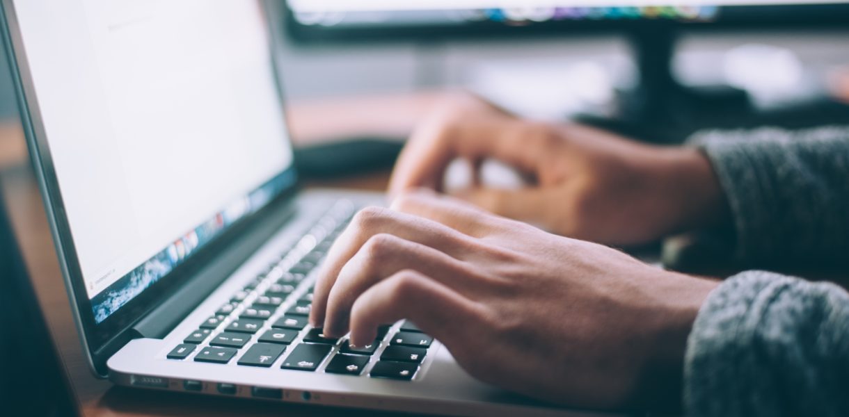 Person using a laptop and demonstrating Digital Transformation