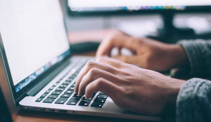 Person using a laptop and demonstrating Digital Transformation