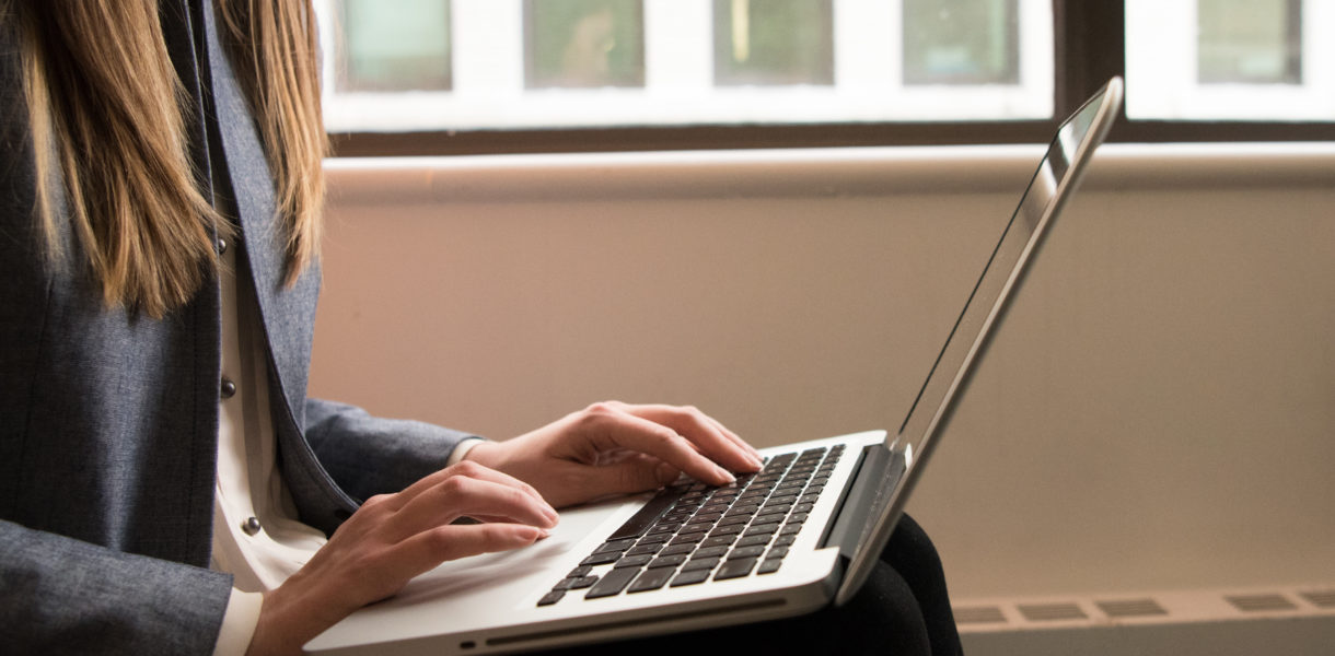 Woman using a laptop in the fintech industry, from #WOCinTech Chat