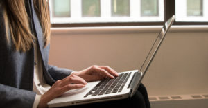 Woman using a laptop in the fintech industry, from #WOCinTech Chat