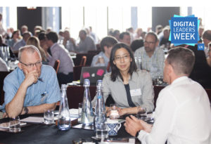 professional men and women discussing a topic around a table