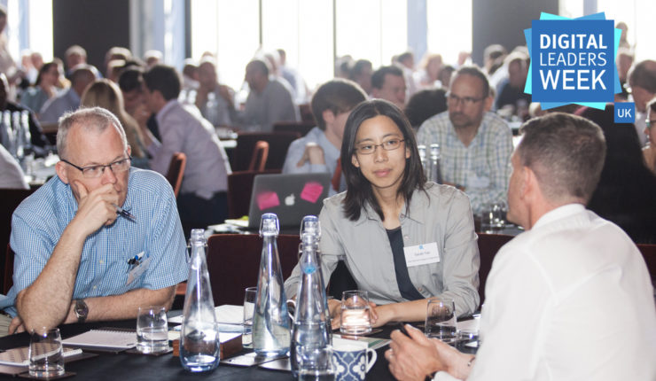 professional men and women discussing a topic around a table