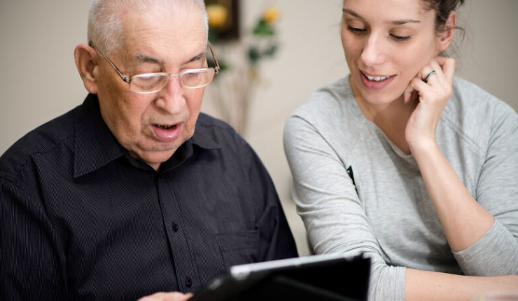 Older person mentored in using technology to combat digital exclusion