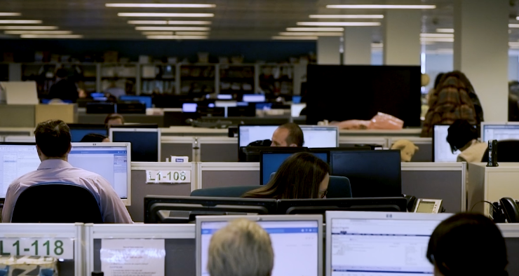 Local Government office with lots of people using computers and AI in shot