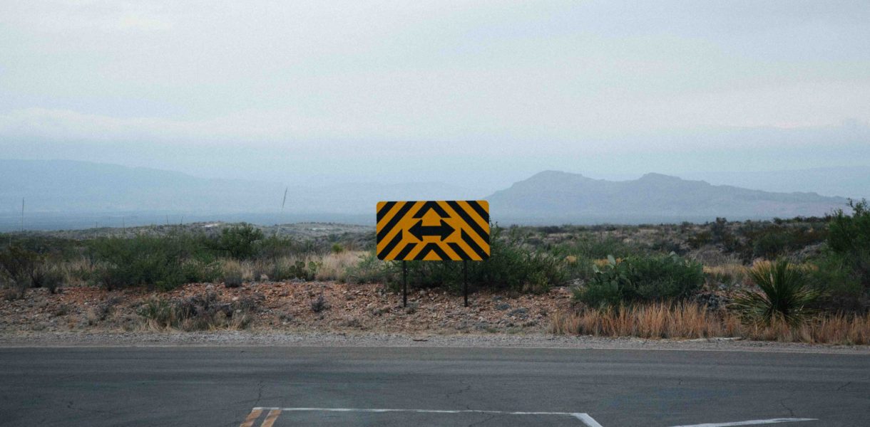 Image of a cross roads sign pointing in two possible directions