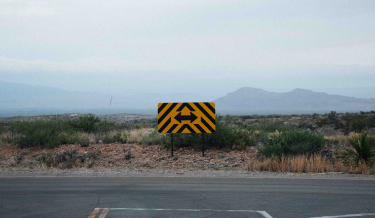 Image of a cross roads sign pointing in two possible directions
