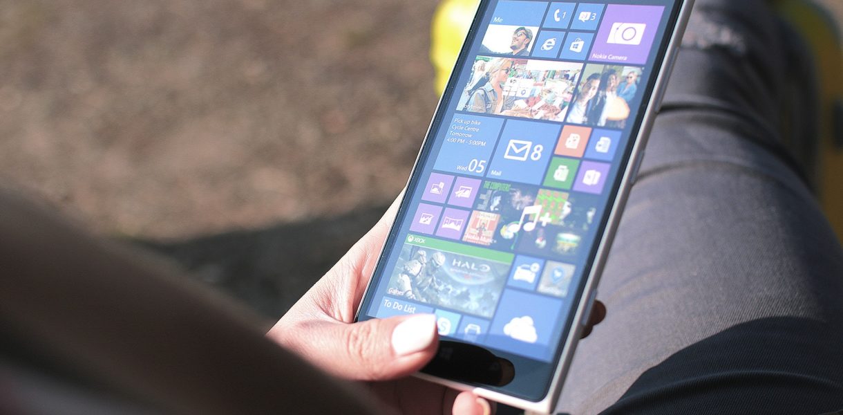 Someone using a tablet with menu of apps open