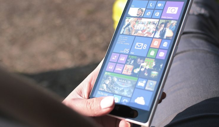 Someone using a tablet with menu of apps open