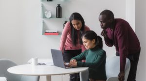 Friends look on a laptop