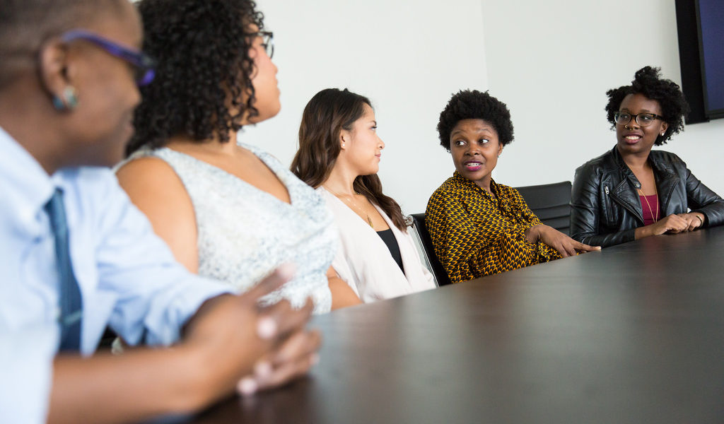 5 people in a meeting speaking around a table - soft data and feedback as this blog suggests