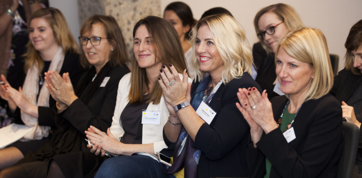 Women in a row clapping for Diversity