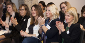 Women in a row clapping for Diversity