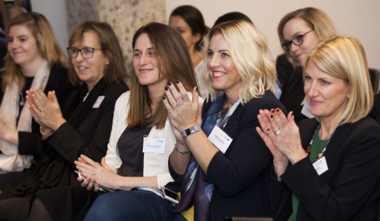 Women in a row clapping for Diversity