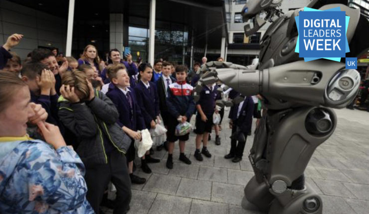 large robot talking to a group of children