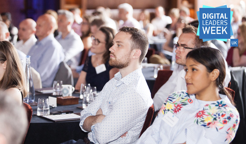 a group of professional people listening to a speaker