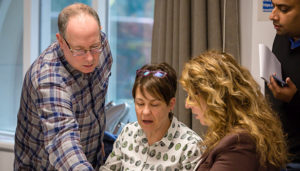 4 people looking at a document around a table