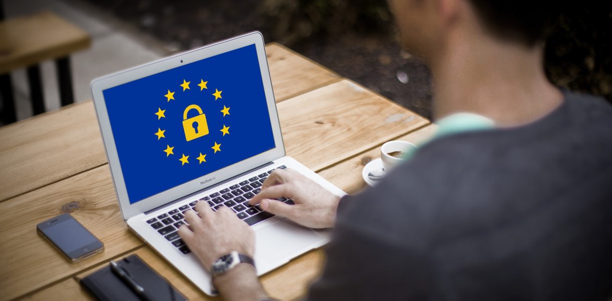 Man on laptop with GDPR and EU symbol on the screen