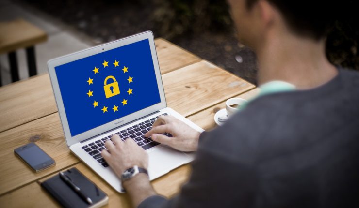 Man on laptop with GDPR and EU symbol on the screen