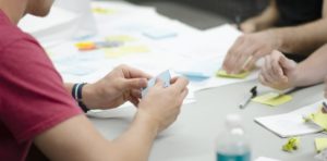 People doing Agile work at a desk around User Research