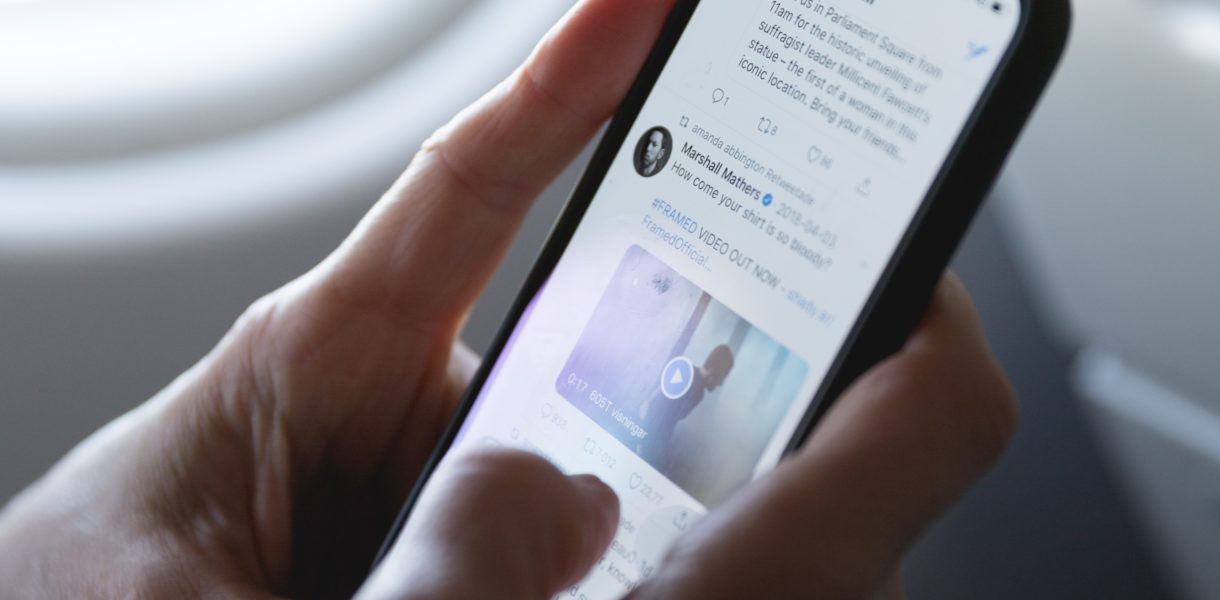 Person holding phone whilst on the twitter app