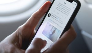 Person holding phone whilst on the twitter app