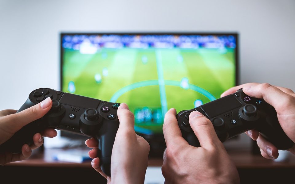 People using video game controllers to play fifa