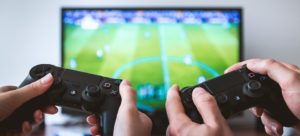 People using video game controllers to play fifa