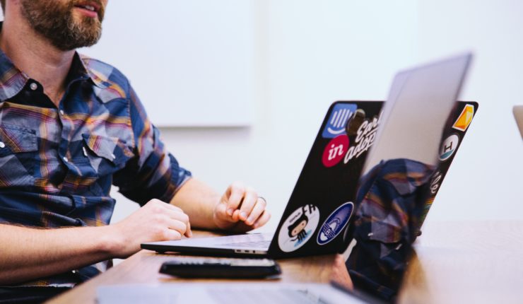 Guy at a desk on a laptop discussing digital change
