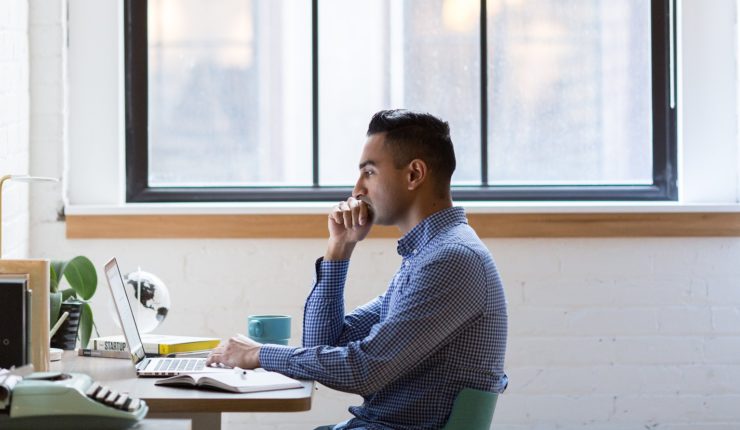 man on laptop at a desk