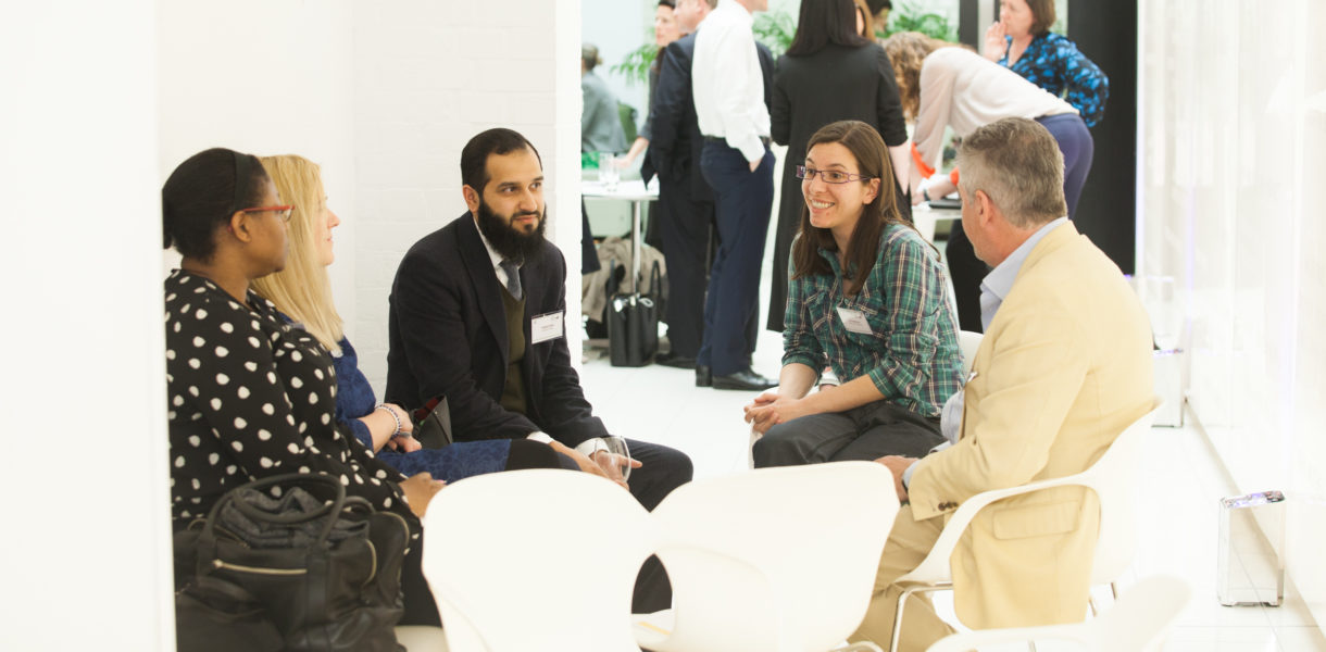 A diverse group of people around a table in discussion
