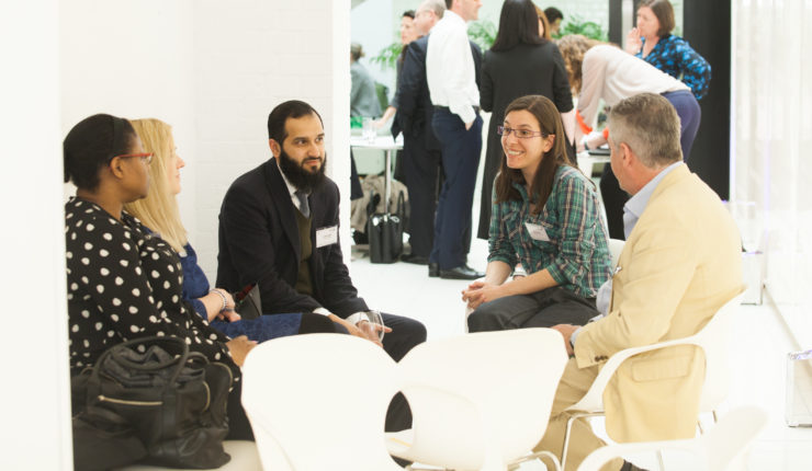 A diverse group of people around a table in discussion