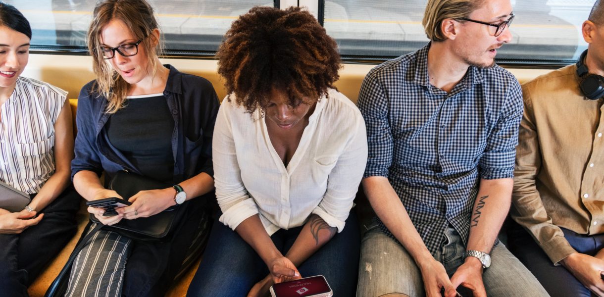 Citizens on a train on their electronic devices
