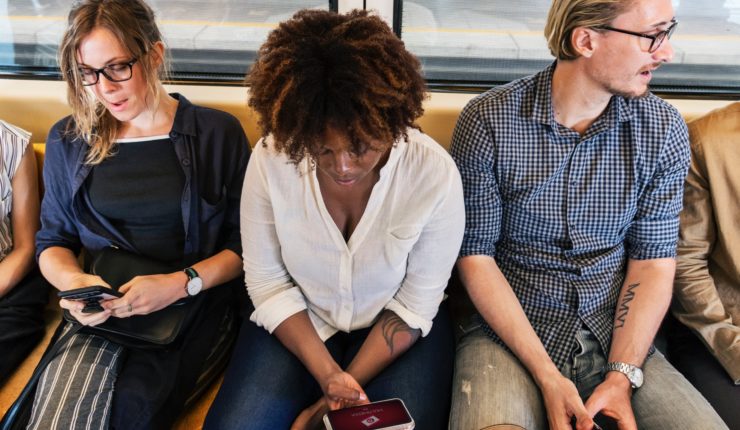 Citizens on a train on their electronic devices