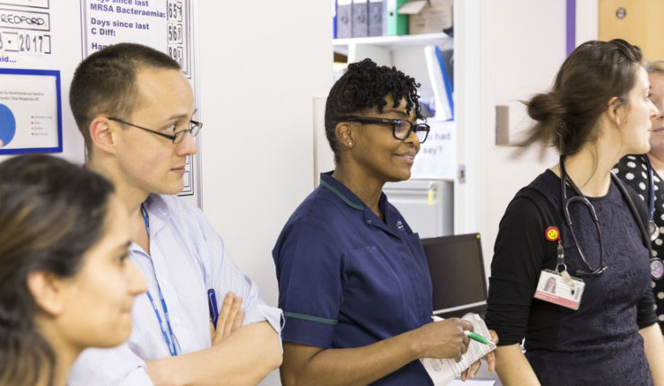 Doctors and nurses gather in a meeting about digital health