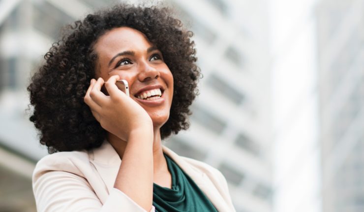 Woman in business attire on her mobile phone