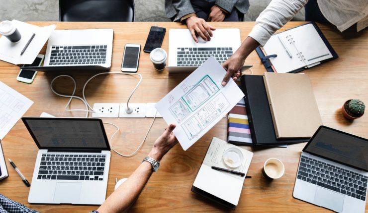 Data driven team around a table with laptops