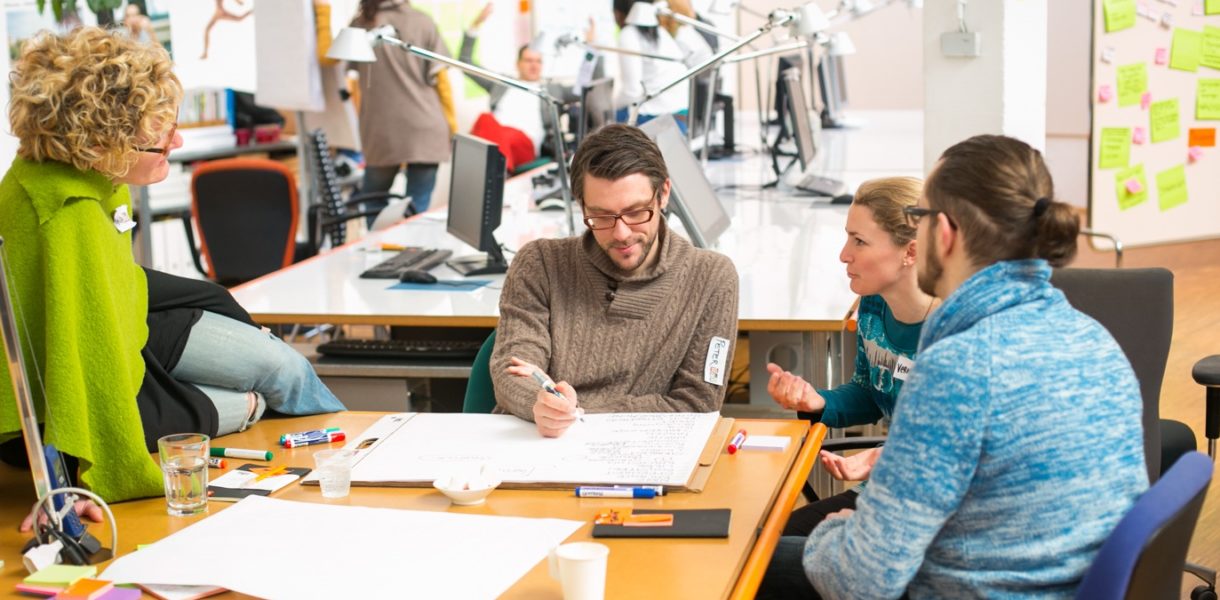 Team sitting around a table working on a project together