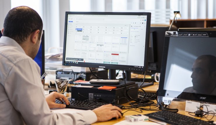 Man sat at a desk using the computer