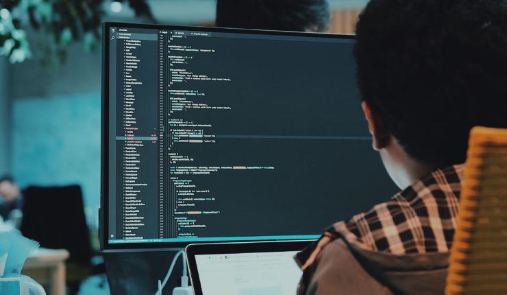 Someone using a computer to edit computer code