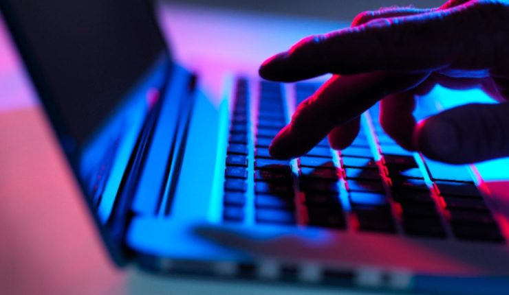 Someone typing on a laptop keyboard