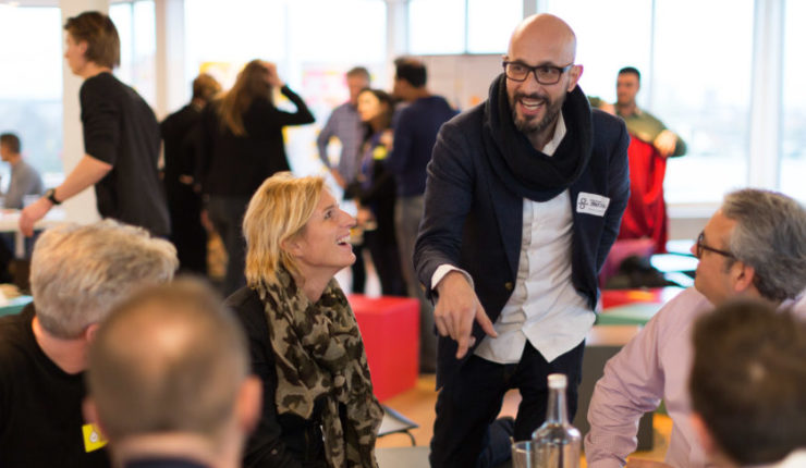 People talking around a table at a networking event
