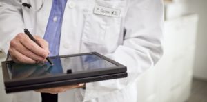 Doctor writing on Ipad