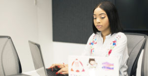 woman using two computers