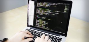 man coding on computer