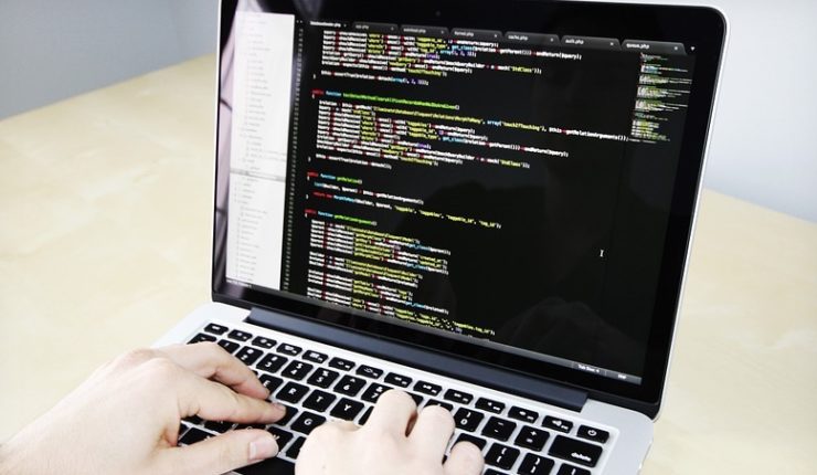 man coding on computer