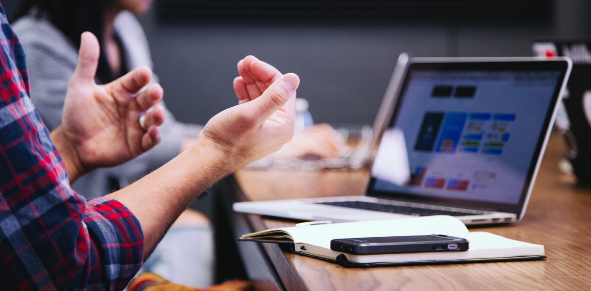 man sitting next to computer
