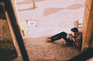 Teen sitting alone using his phone