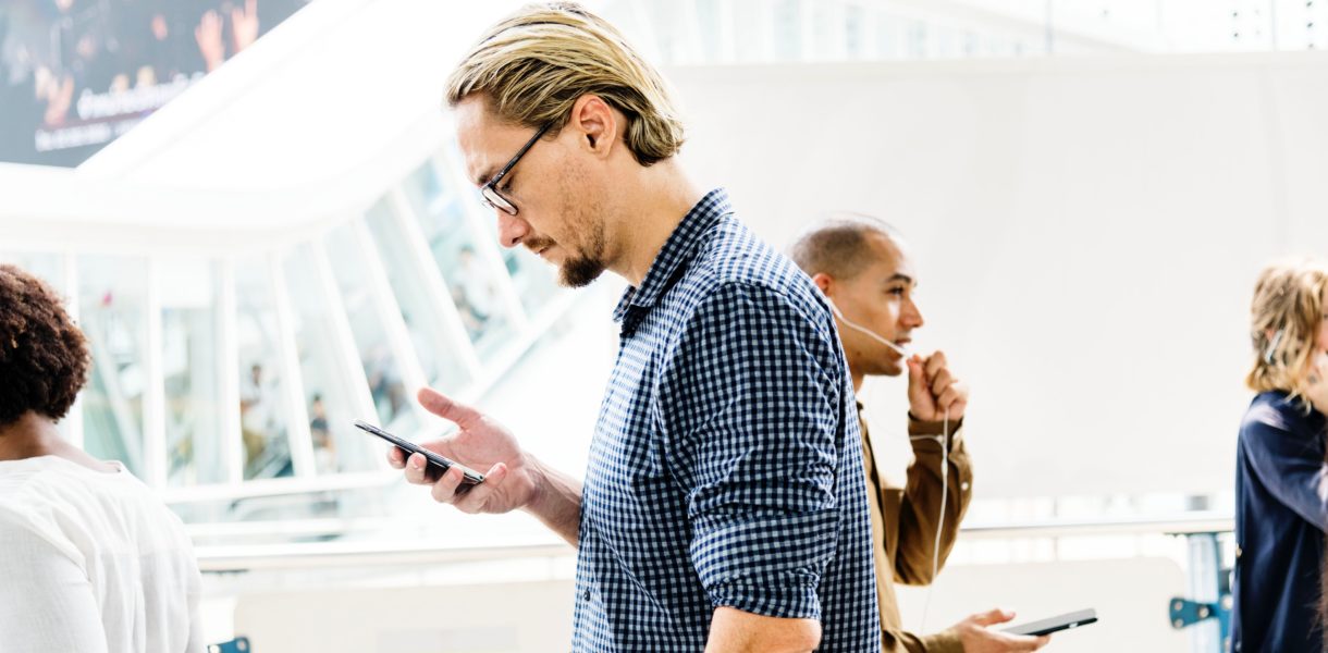 man walking with phone in hand