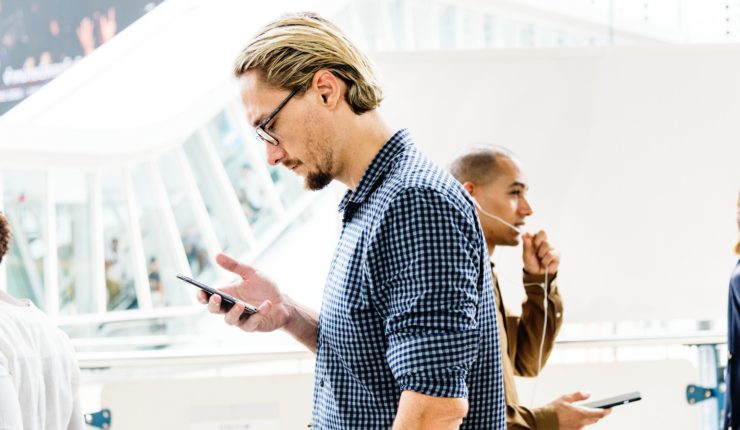 man walking with phone in hand